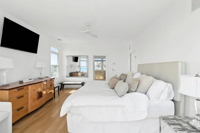 a bedroom with a large bed and a flat screen tv