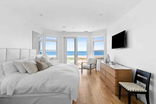 a bedroom with a bed and glass window