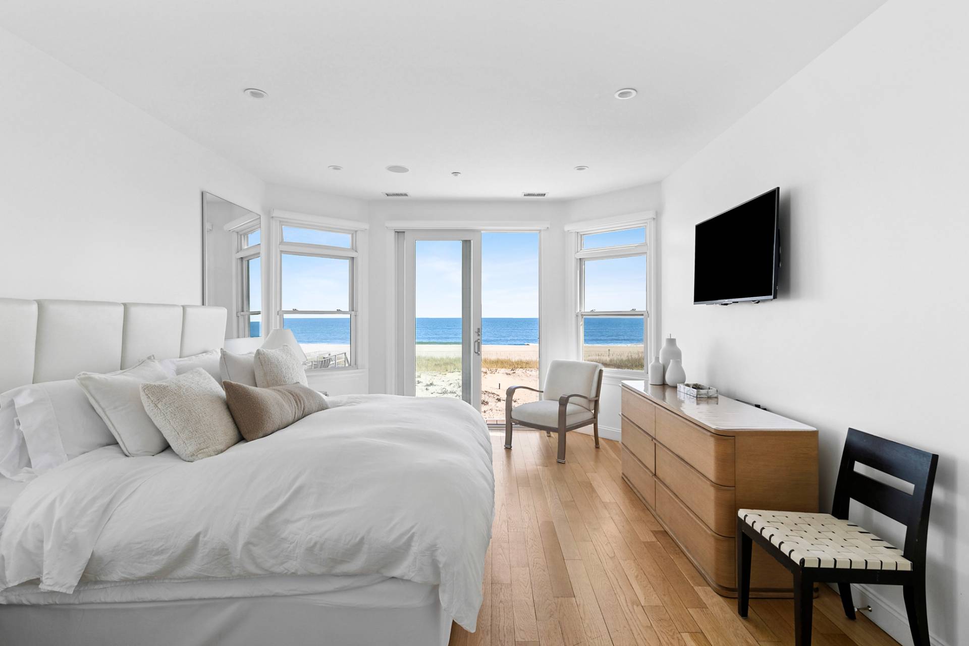 687 Dune Road Westhampton Beach, NY 11978 - Photo 17 of 24 a bedroom with a bed and glass window