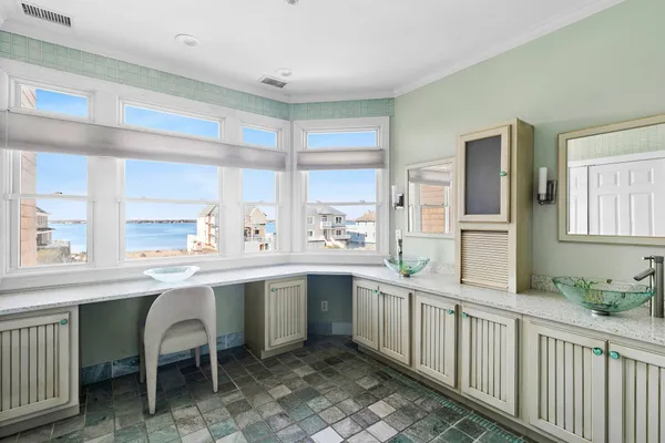 a kitchen with a sink and chairs
