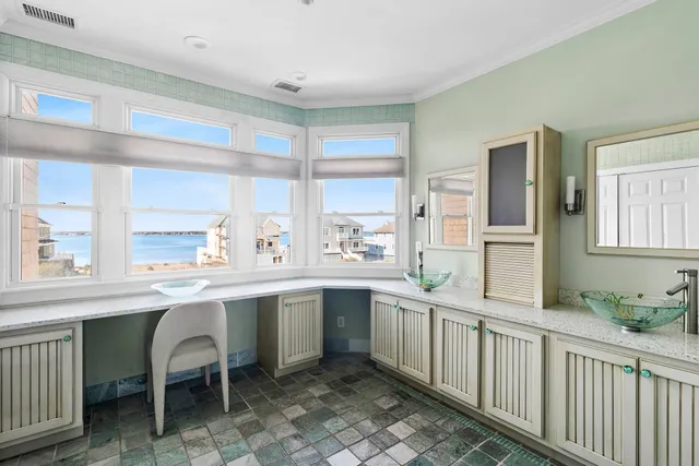 a kitchen with a sink and chairs