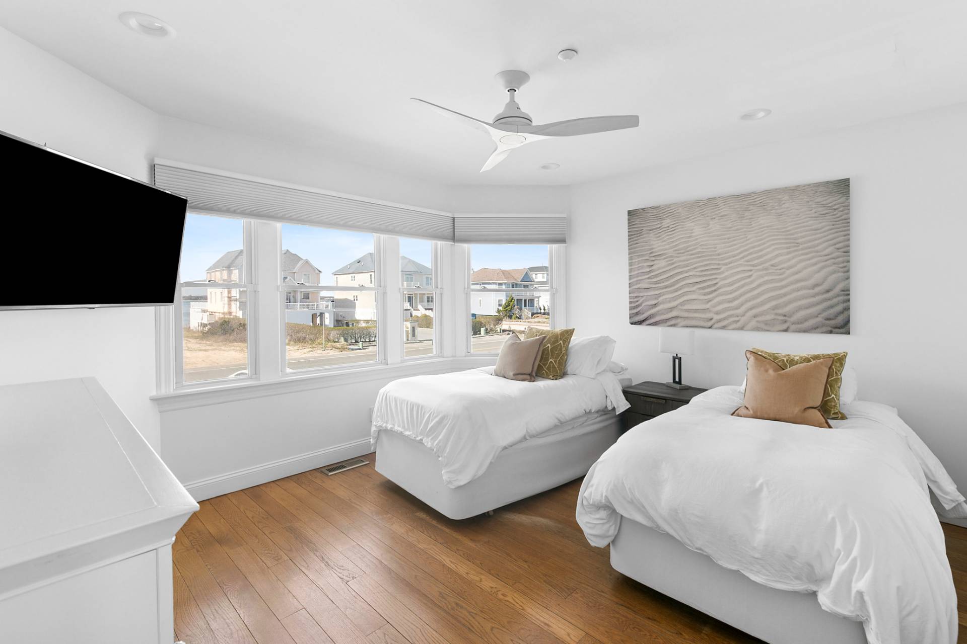 687 Dune Road Westhampton Beach, NY 11978 - Photo 20 of 24 a bedroom with two beds and a flat screen tv