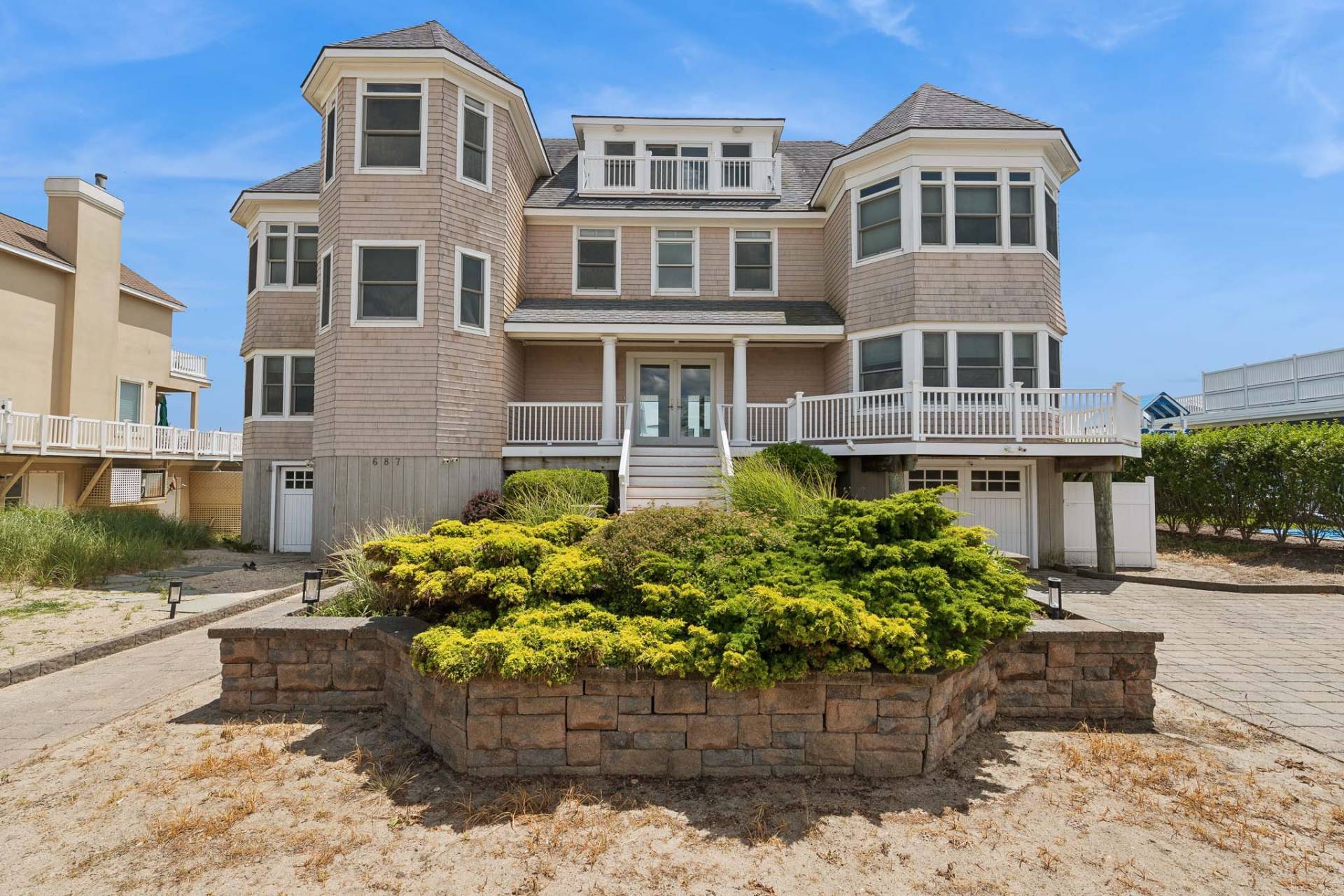 687 Dune Road Westhampton Beach, NY 11978 - Photo 23 of 24 a front view of a house with a yard