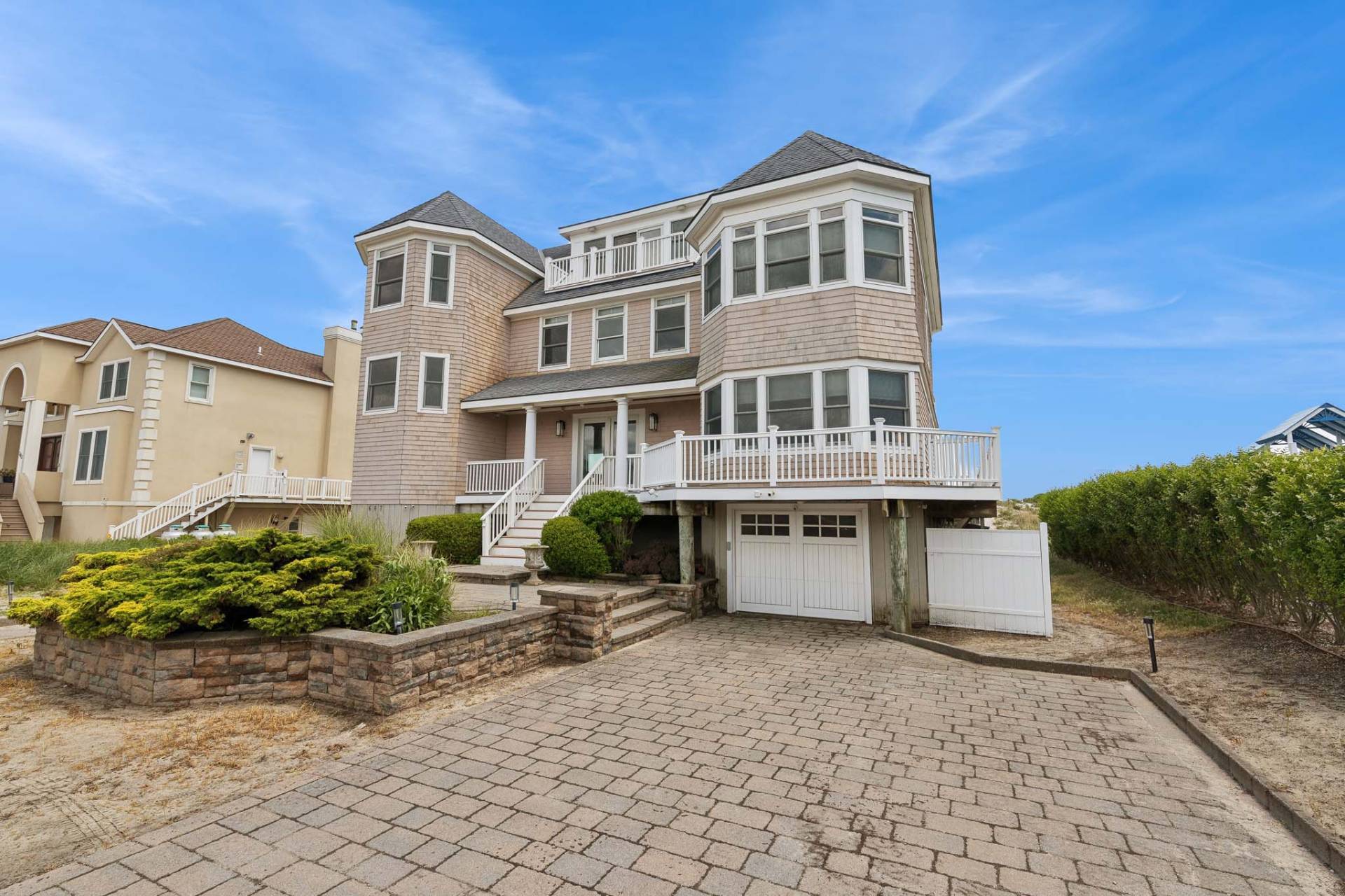 687 Dune Road Westhampton Beach, NY 11978 - Photo 24 of 24 a front view of a house with a garden