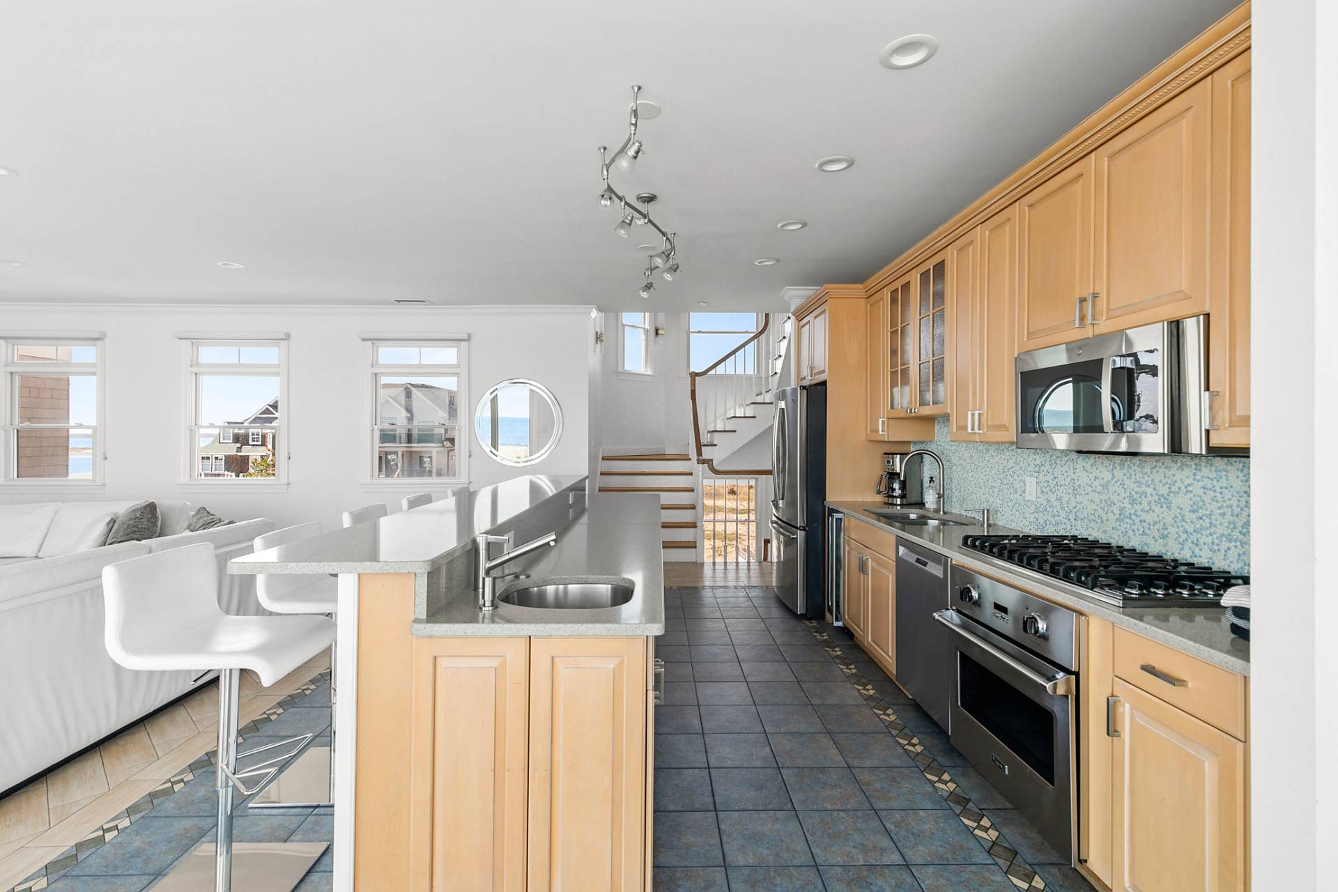 687 Dune Road Westhampton Beach, NY 11978 - Photo 3 of 24 a kitchen with stainless steel appliances a stove sink microwave and cabinets