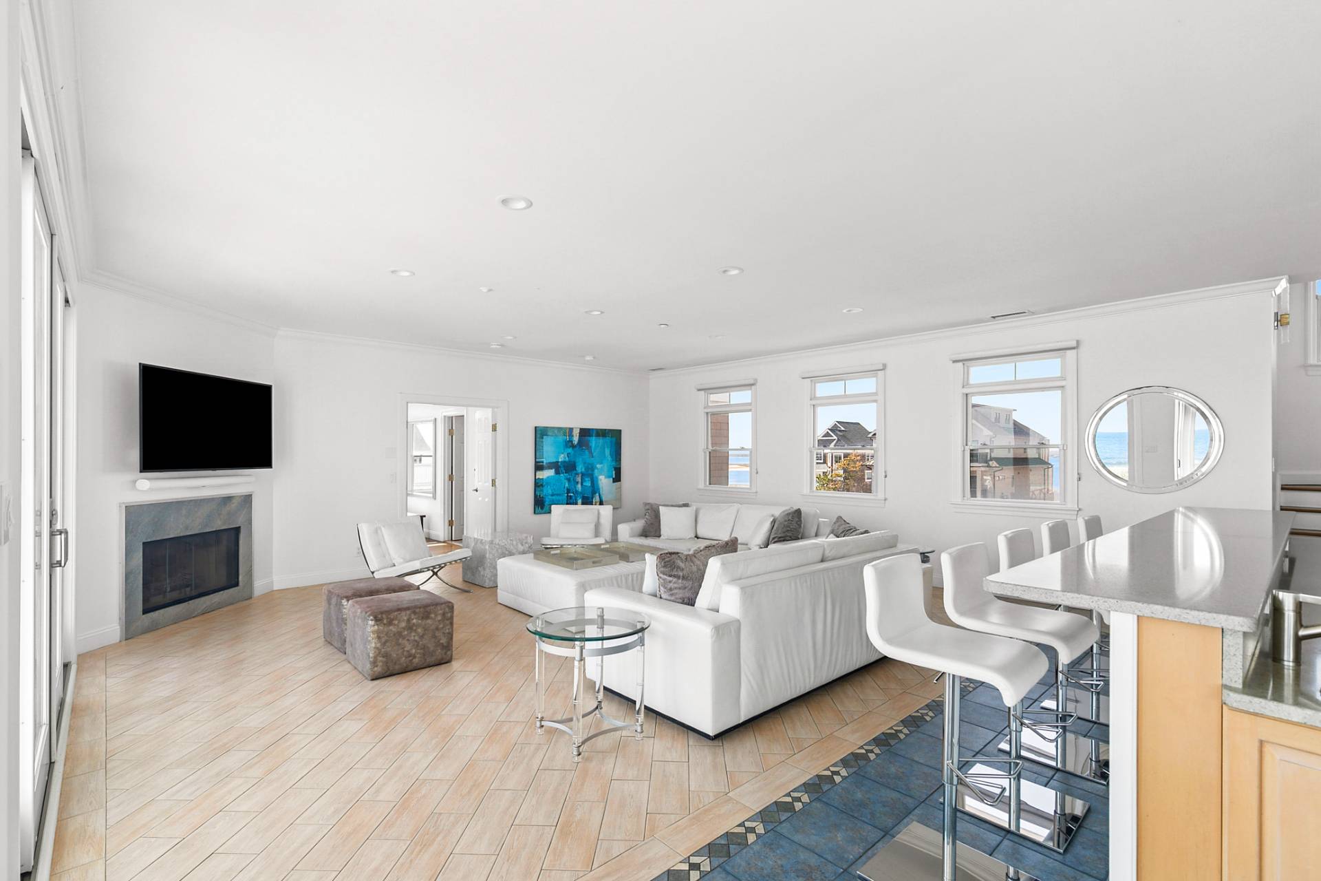 687 Dune Road Westhampton Beach, NY 11978 - Photo 4 of 24 a living room with furniture a flat screen tv and a fireplace