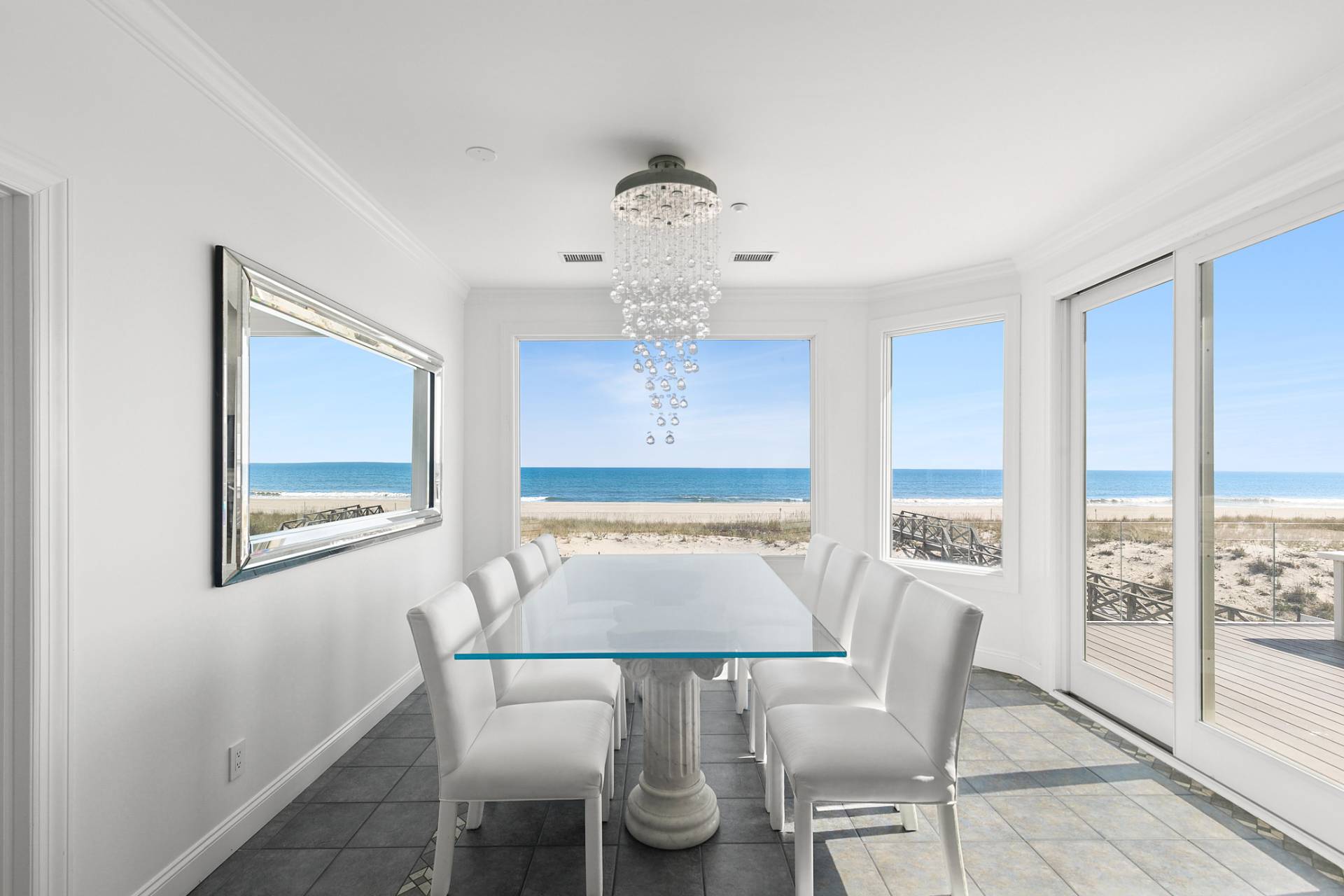 687 Dune Road Westhampton Beach, NY 11978 - Photo 5 of 24 a view of a dining room with furniture window and wooden floor