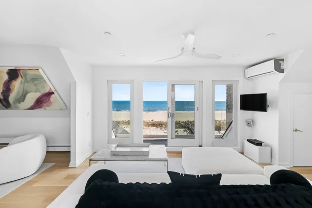 a living room with furniture a large window and a flat screen tv