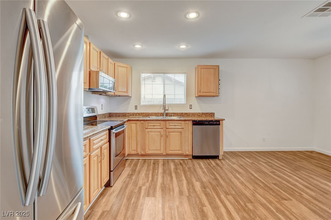 4430 Eureka Circle Las Vegas, NV 89103 - Photo 15 of 39 Kitchen with light wood finished floors, stainless