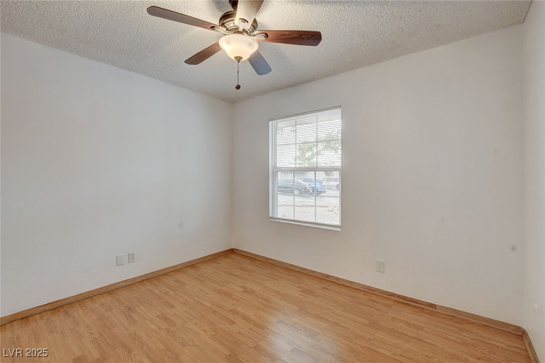 4430 Eureka Circle Las Vegas, NV 89103 - Photo 18 of 39 Empty room with baseboards, light wood-style floor
