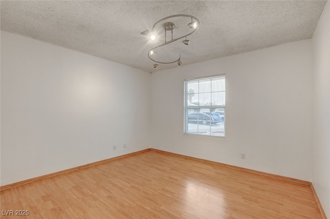 4430 Eureka Circle Las Vegas, NV 89103 - Photo 21 of 39 Empty room featuring baseboards, a chandelier, a t