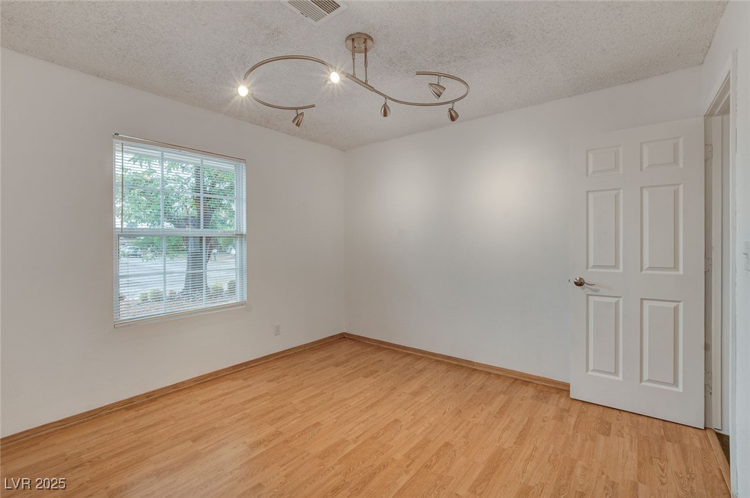 4430 Eureka Circle Las Vegas, NV 89103 - Photo 22 of 39 Spare room featuring an inviting chandelier, a tex