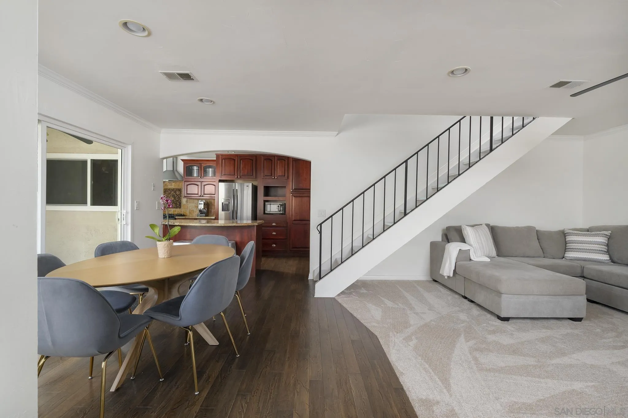 183 Countryhaven Road Encinitas, CA 92024 - Photo 3 of 28 a living room with couches and a dining table with wooden floor