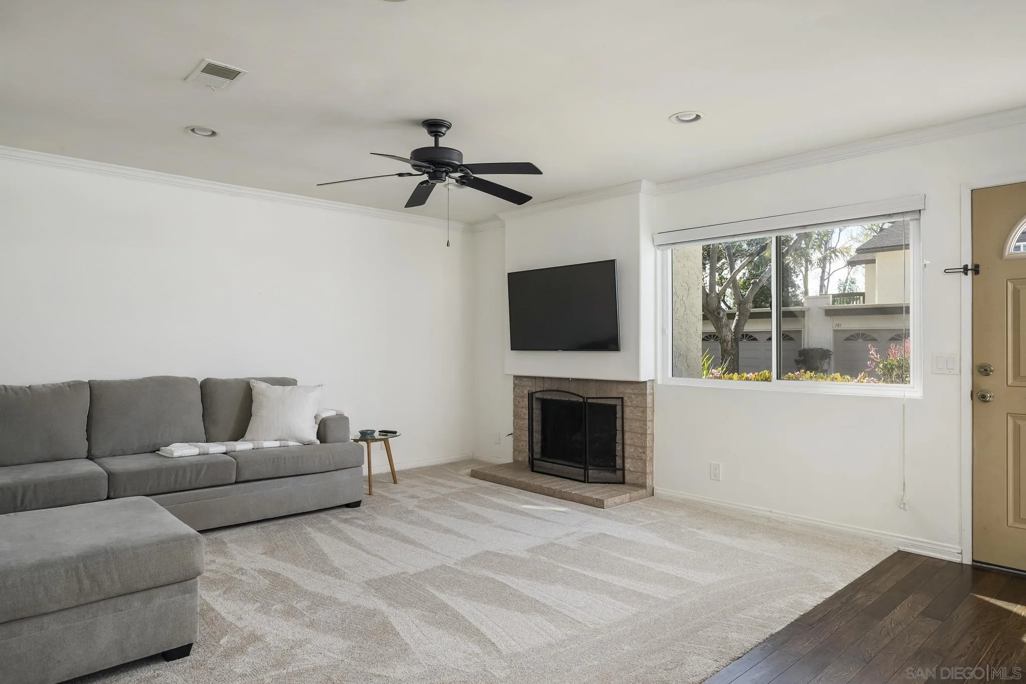 183 Countryhaven Road Encinitas, CA 92024 - Photo 7 of 28 a living room with furniture a flat screen tv and a fireplace