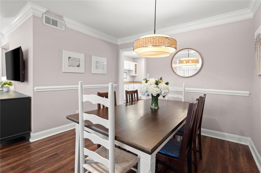 6980 Roswell Road, Unit F7 Atlanta, GA 30328 - Photo 11 of 43 a view of a dining room with furniture and wooden floor