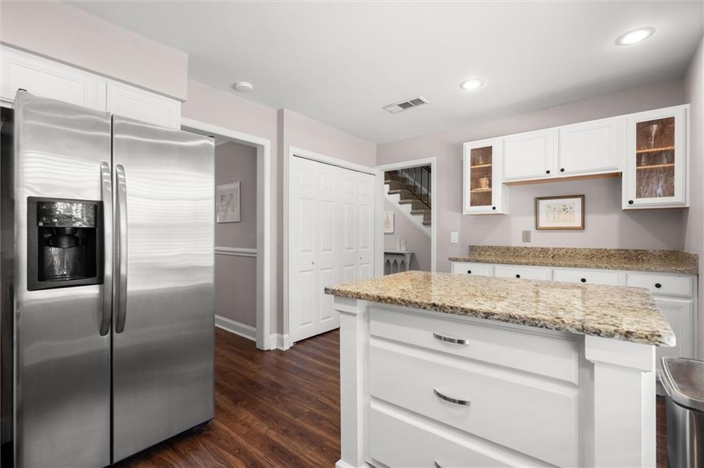 6980 Roswell Road, Unit F7 Atlanta, GA 30328 - Photo 17 of 43 a kitchen with stainless steel appliances granite countertop a refrigerator and a sink