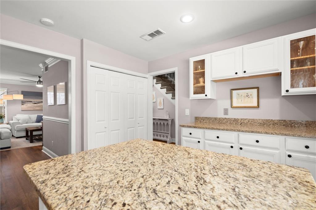 6980 Roswell Road, Unit F7 Atlanta, GA 30328 - Photo 19 of 43 a bedroom with a bed and wooden floor
