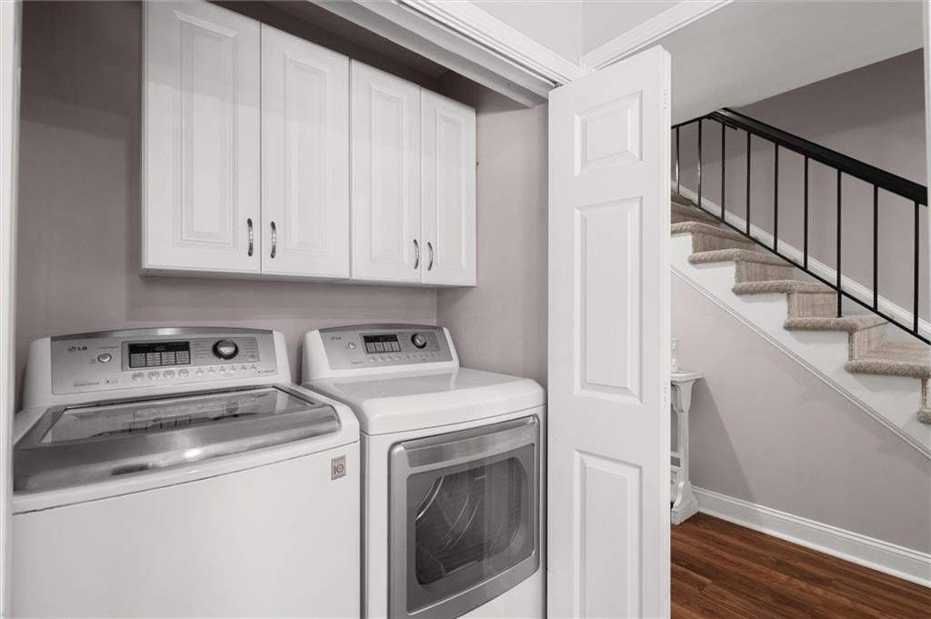 6980 Roswell Road, Unit F7 Atlanta, GA 30328 - Photo 20 of 43 a view of washer and dryer with white cabinets