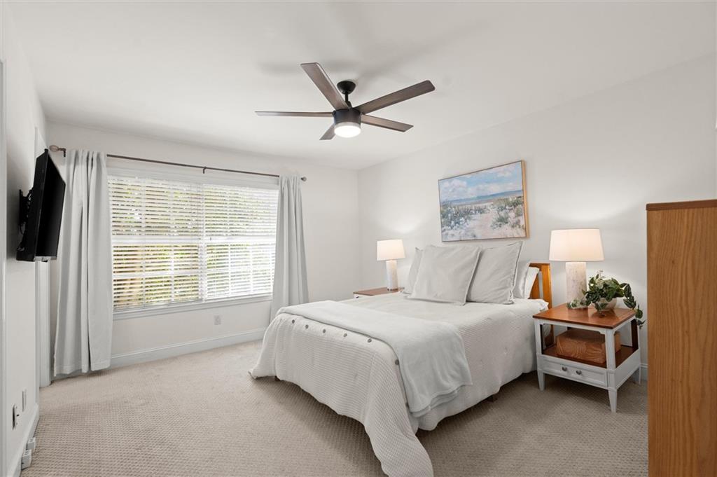 6980 Roswell Road, Unit F7 Atlanta, GA 30328 - Photo 25 of 43 a bedroom with a bed couch and a window