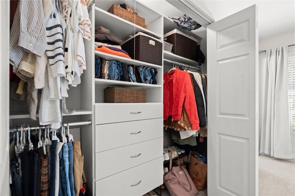 6980 Roswell Road, Unit F7 Atlanta, GA 30328 - Photo 29 of 43 a view of walk in closet with clothes and shoes