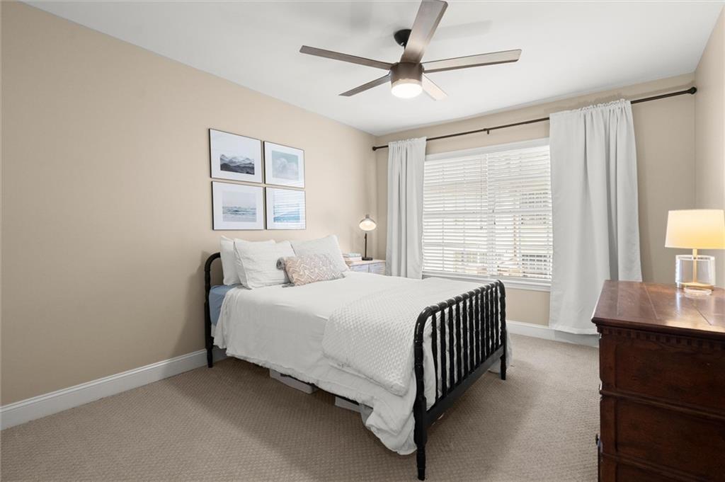 6980 Roswell Road, Unit F7 Atlanta, GA 30328 - Photo 30 of 43 a spacious bedroom with a bed a dresser and a window