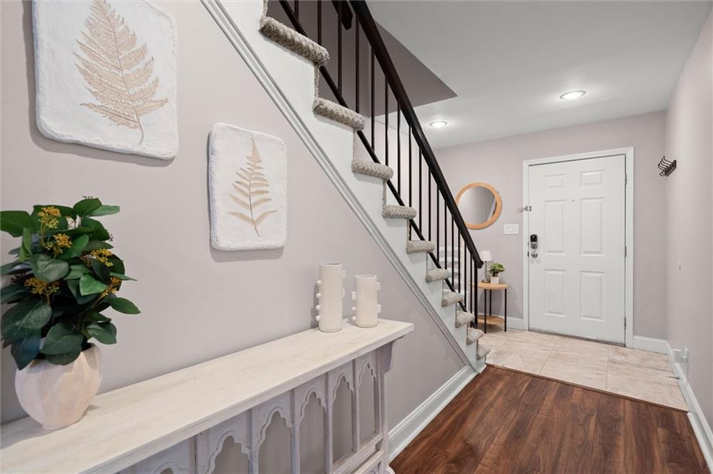6980 Roswell Road, Unit F7 Atlanta, GA 30328 - Photo 3 of 43 a view of entryway and hall with wooden floor
