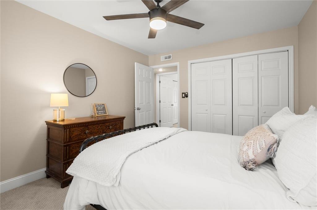 6980 Roswell Road, Unit F7 Atlanta, GA 30328 - Photo 31 of 43 a bedroom with a bed and a chandelier