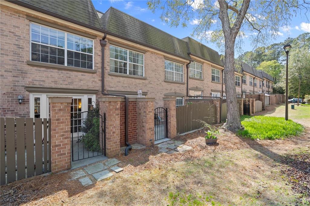 6980 Roswell Road, Unit F7 Atlanta, GA 30328 - Photo 32 of 43 a front view of a house with a yard