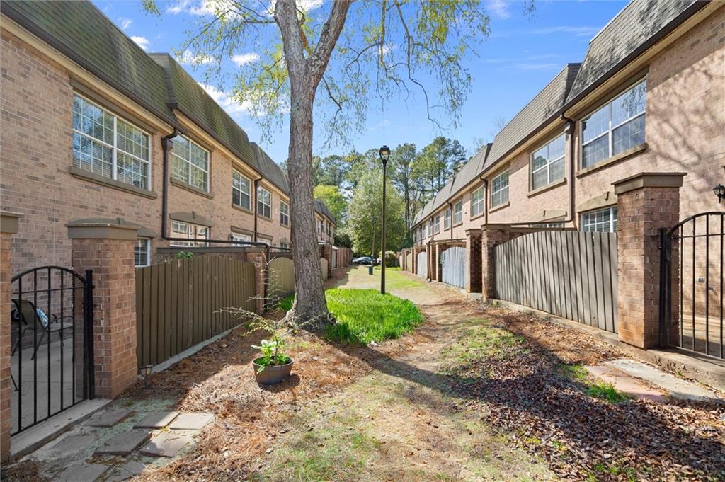 6980 Roswell Road, Unit F7 Atlanta, GA 30328 - Photo 34 of 43 a view of a house with a yard