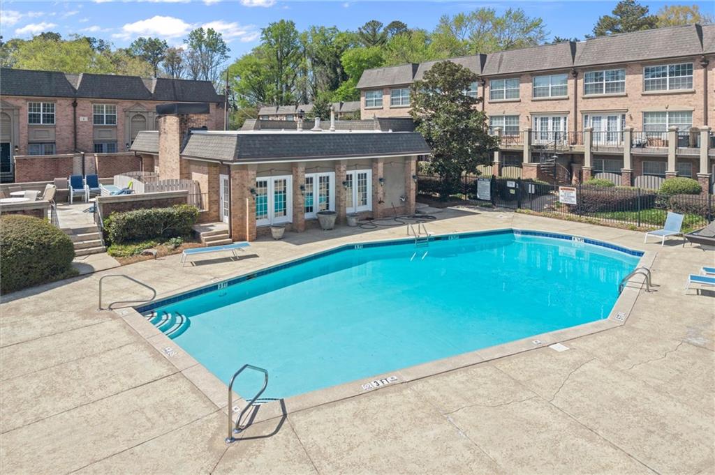 6980 Roswell Road, Unit F7 Atlanta, GA 30328 - Photo 36 of 43 a view of a house with pool and chairs