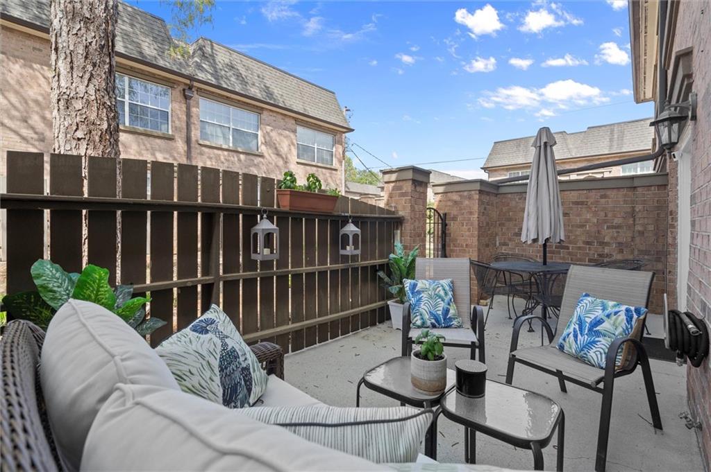6980 Roswell Road, Unit F7 Atlanta, GA 30328 - Photo 6 of 43 a view of a patio with couches table and chairs and potted plants