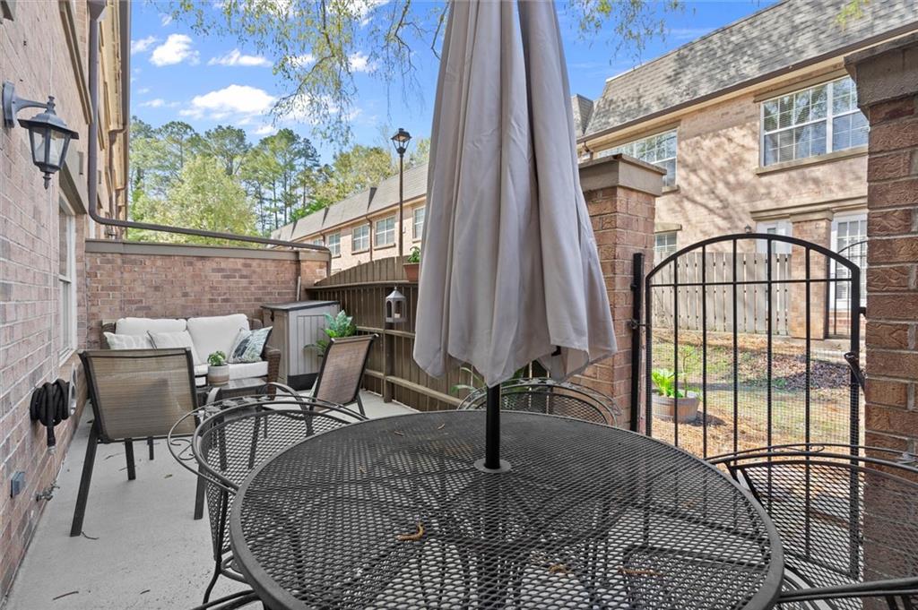 6980 Roswell Road, Unit F7 Atlanta, GA 30328 - Photo 7 of 43 a view of a porch with furniture and floor to ceiling window