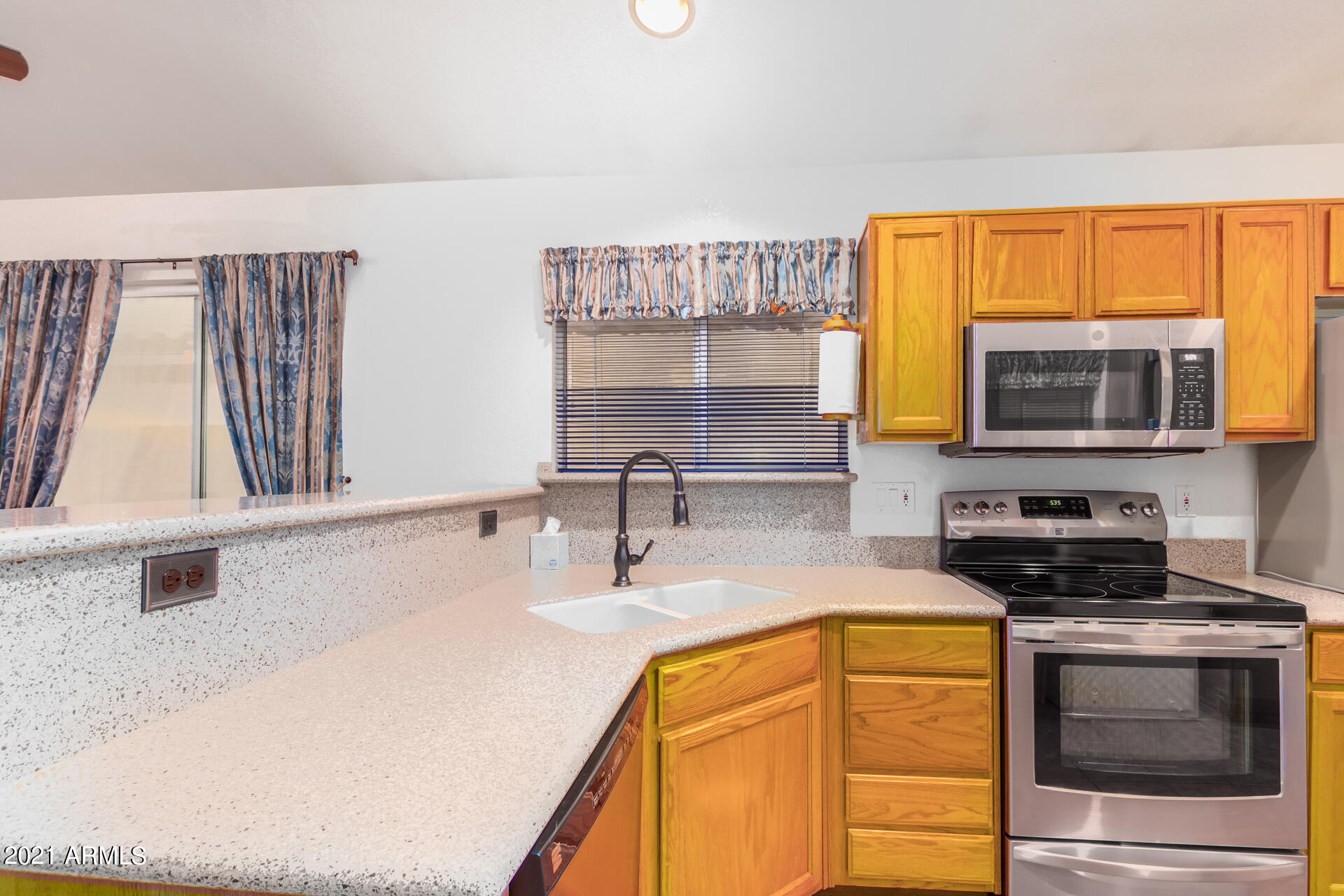4138 West Bloomfield Road Phoenix, AZ 85029 - Photo 8 of 28 a kitchen with stainless steel appliances granite countertop a sink and a stove next to a window