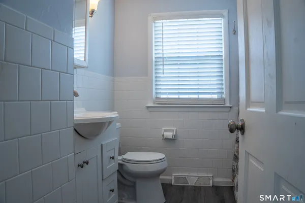 a bathroom with a toilet a sink and window