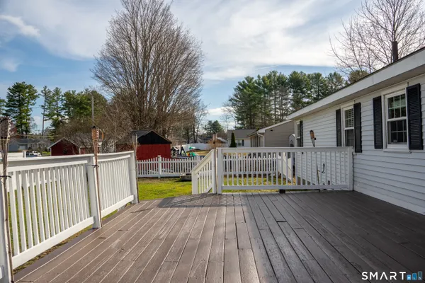 a view of a house with pool and deck