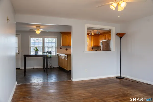 a view of a livingroom with furniture window and wooden floor