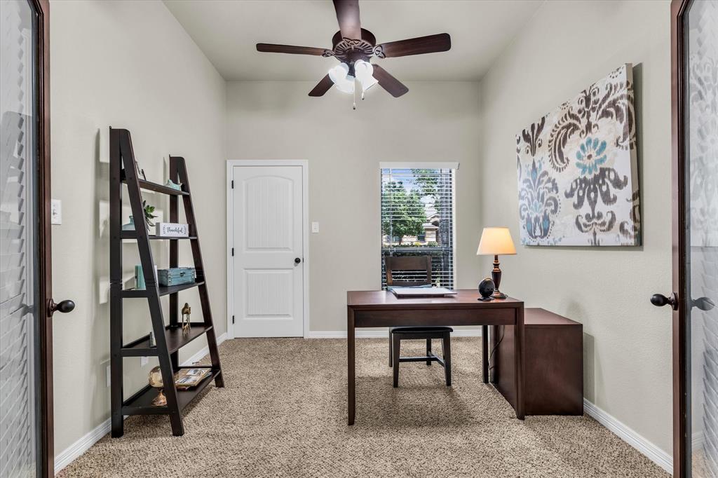 814 Springdale Circle Lorena, TX 76655 - Photo 21 of 37 Carpeted room featuring a ceiling fan with integrated lighting, a paneled door, and a window with blinds