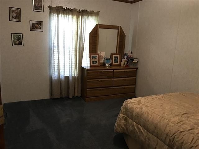 1364 Big Rdg Road Spring City, TN 37381 - Photo 21 of 36 a bedroom with a bed and a mirror