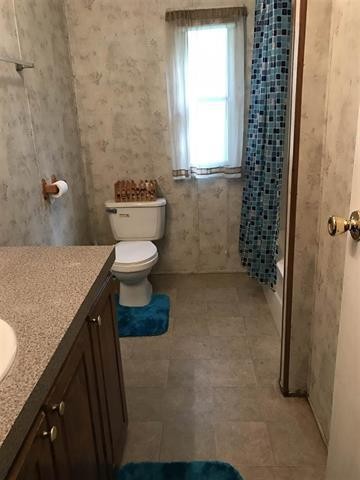 1364 Big Rdg Road Spring City, TN 37381 - Photo 23 of 36 a bathroom with a granite countertop sink toilet and shower