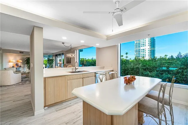 a kitchen with a dining table chairs and white cabinets