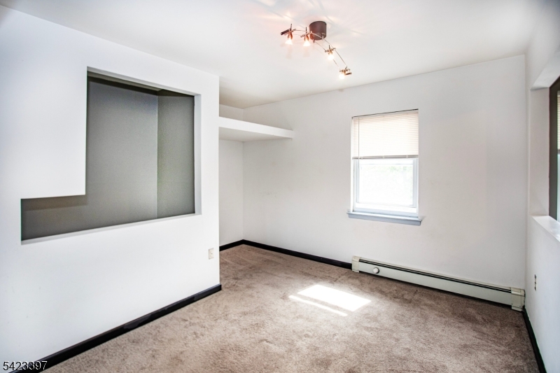 1130 Valley Road, Unit 2B Wayne, NJ 07470 - Photo 13 of 47 a view of an empty room with a window