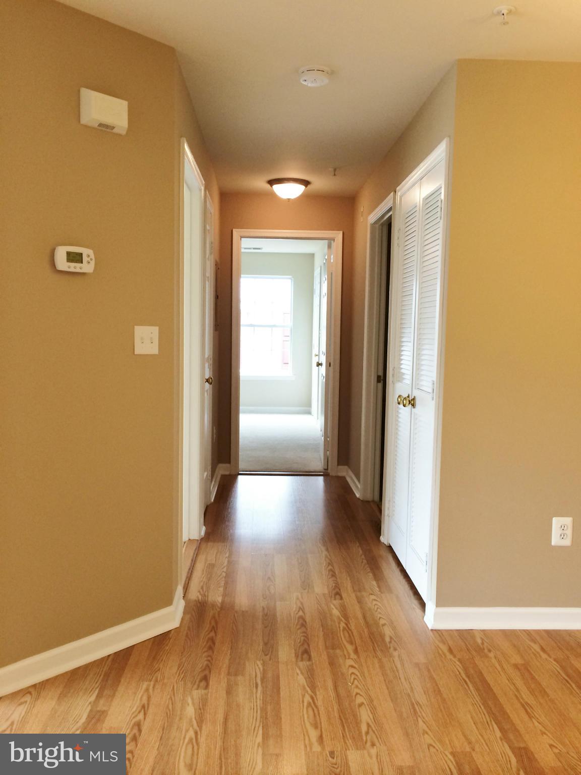 635 Constellation Square Southeast, Unit E Leesburg, VA 20175 - Photo 11 of 20 a view of a hallway with wooden floor