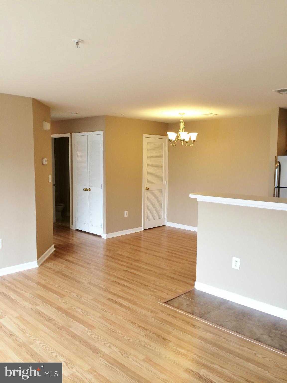 635 Constellation Square Southeast, Unit E Leesburg, VA 20175 - Photo 4 of 20 a view of an empty room with wooden floor
