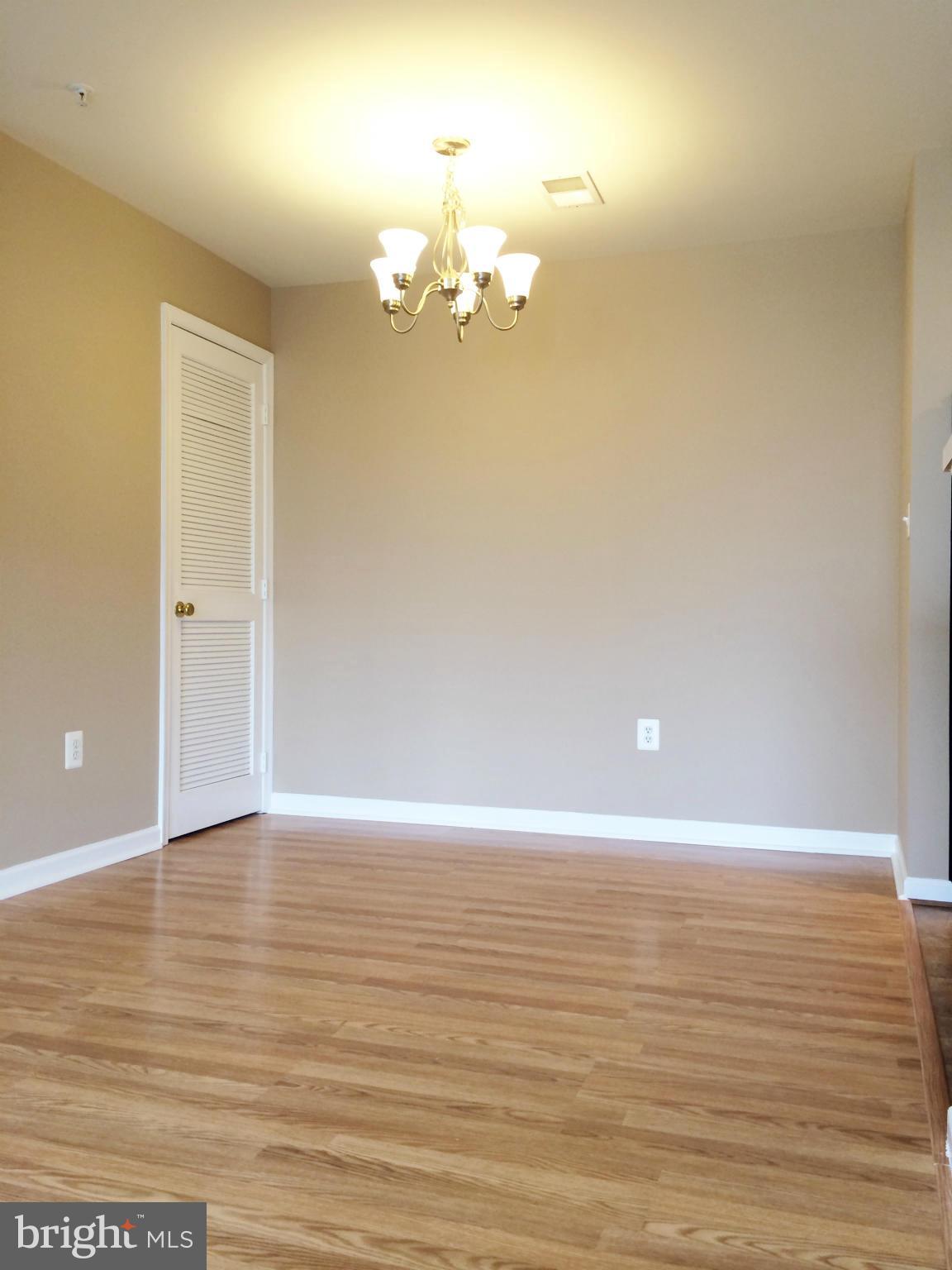 635 Constellation Square Southeast, Unit E Leesburg, VA 20175 - Photo 5 of 20 a view of a room with wooden floor