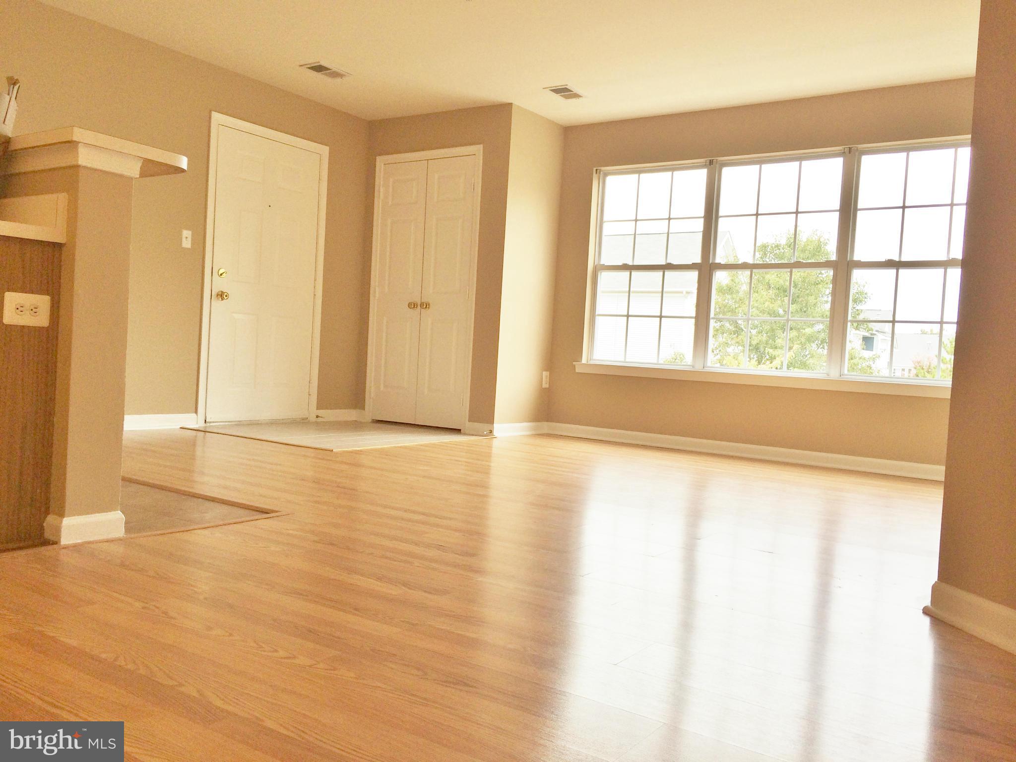 635 Constellation Square Southeast, Unit E Leesburg, VA 20175 - Photo 9 of 20 a view of an empty room with glass door