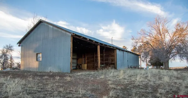 a view of a house with a yard and garage