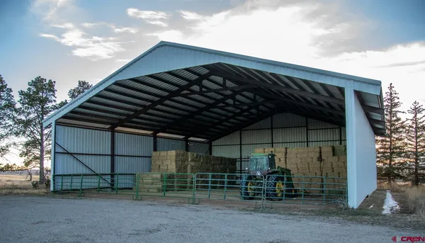 a backyard of a house with barbeque oven and table