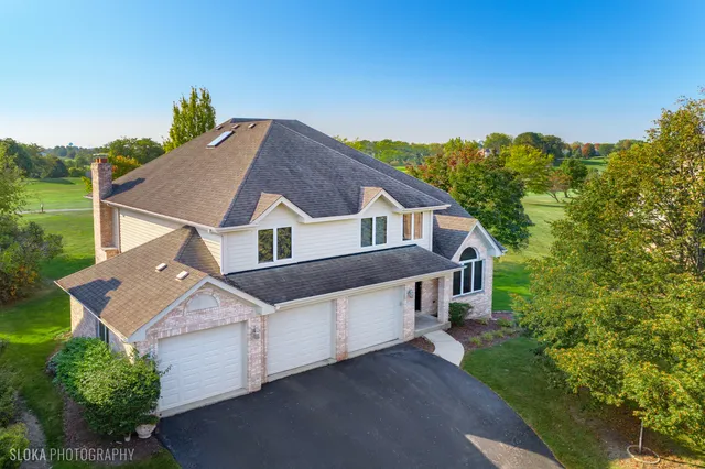 a aerial view of a house next to a yard