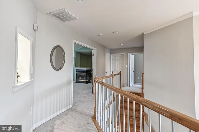 a view of a hallway with entryway wooden floor and front door