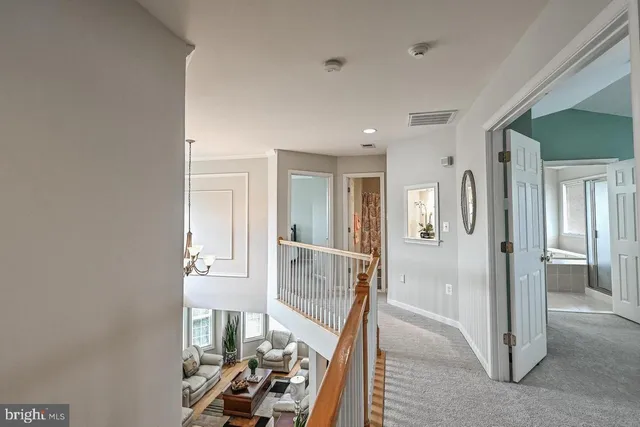 a view of a hallway with wooden floor and bedroom
